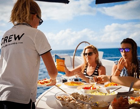 hostess serving drinks on a yacht charter