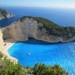 view of shipwreck cove from above with blue water