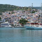 colourful houses and sailing boats in greece on a greek islands yacht charter with skipper