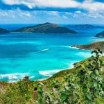 view of the coastline and the water in with islands in the back on a luxury bareboat yacht charter
