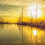 sunset in a marina when booking a sailboat charter